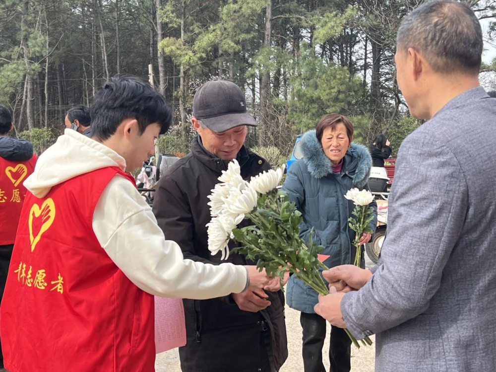 圖為志愿者向群眾發放倡議書，講解文明祭掃理念(1).png